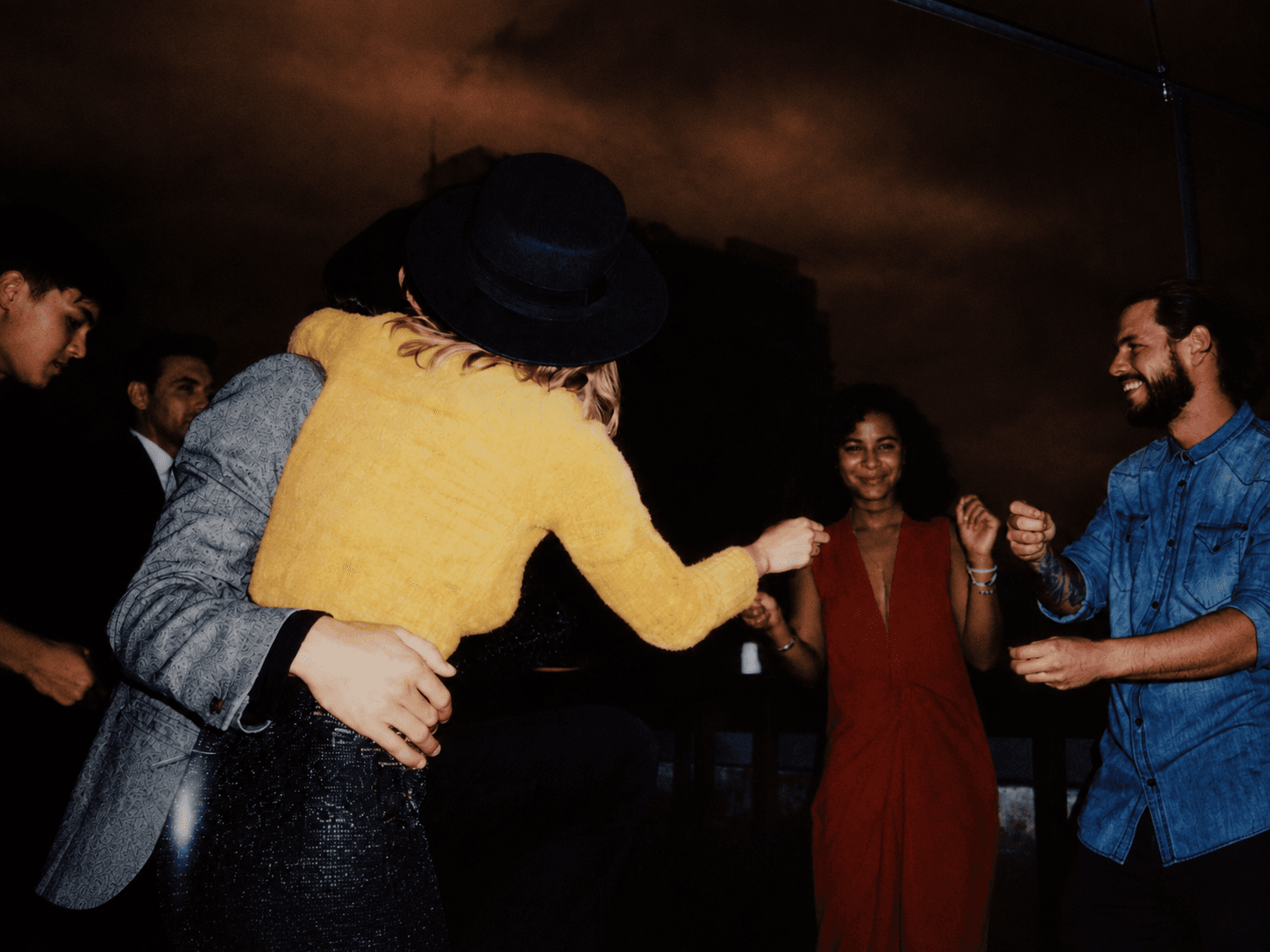 Reddi members dancing together at a rooftop gathering